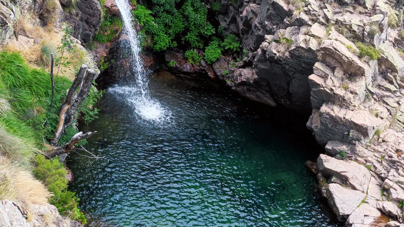 The Radule waterfall dropping into a green pool, above the Col de Vergio