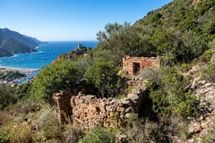 Ruins of a dry-stone shepherd's hut overlooking Porto harbour and its Genoese tower